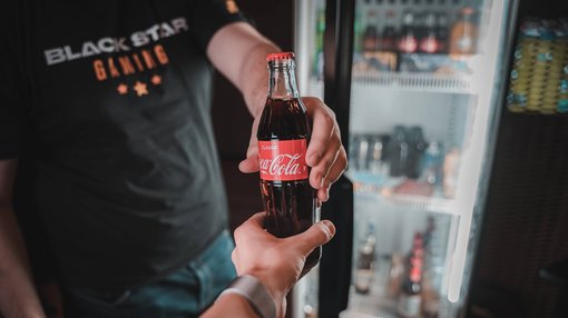 person holding coca cola bottle