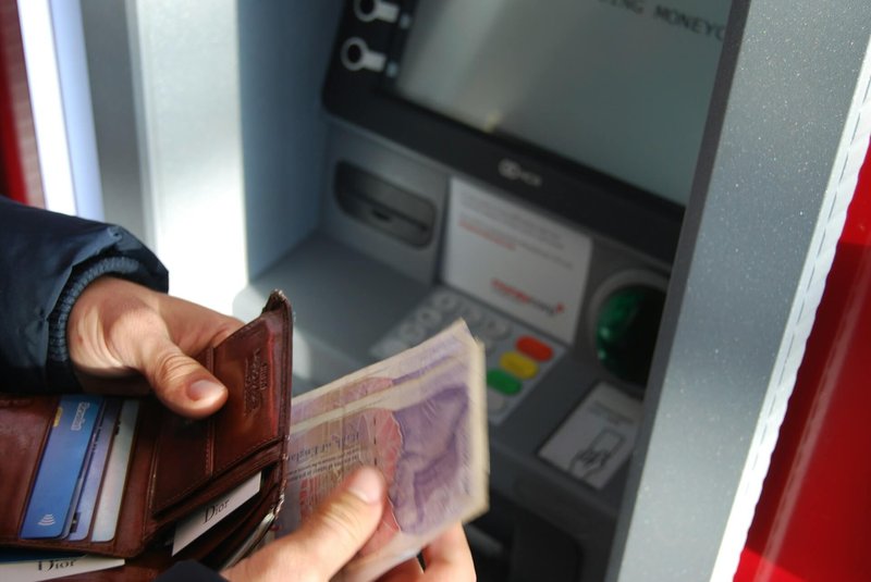 person withdrawing money, UK