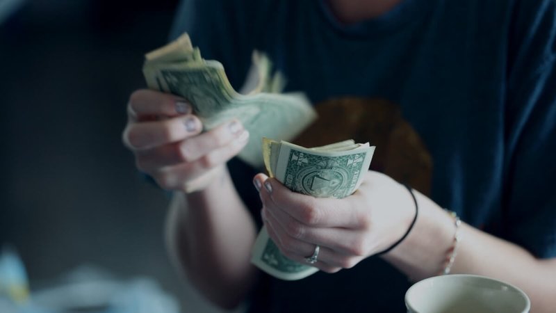 woman counting dollars