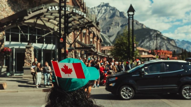 woman with a small Canadian flag in Banff, Canada